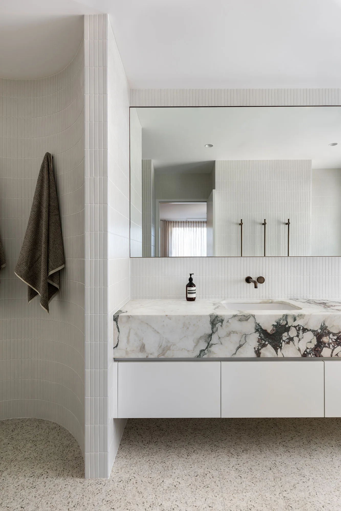 Room by Room Design — bathroom with marble vanity and arched tile detail