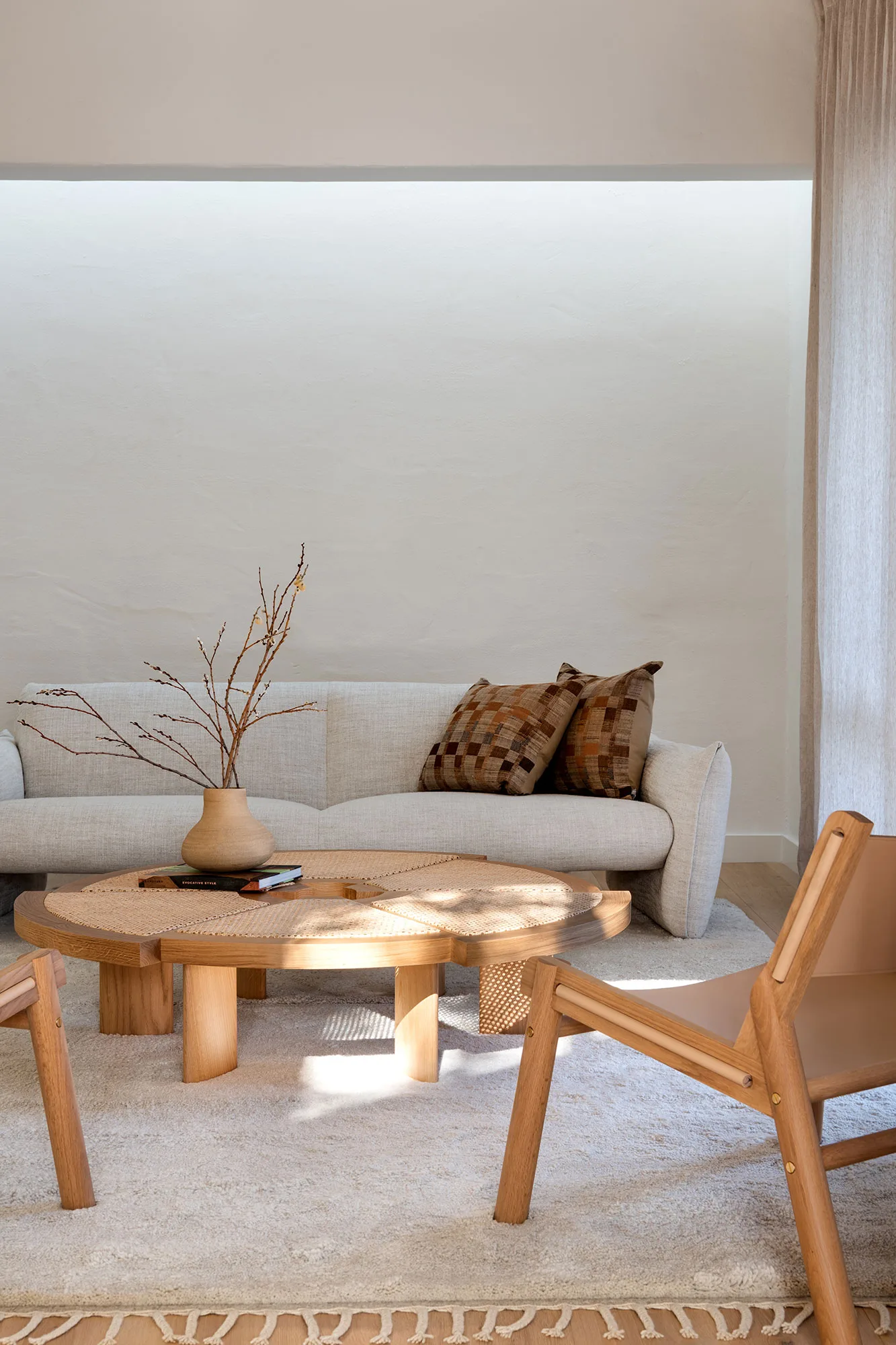 The Refresh — linen sofa with cane coffee table and tan leather sling chair