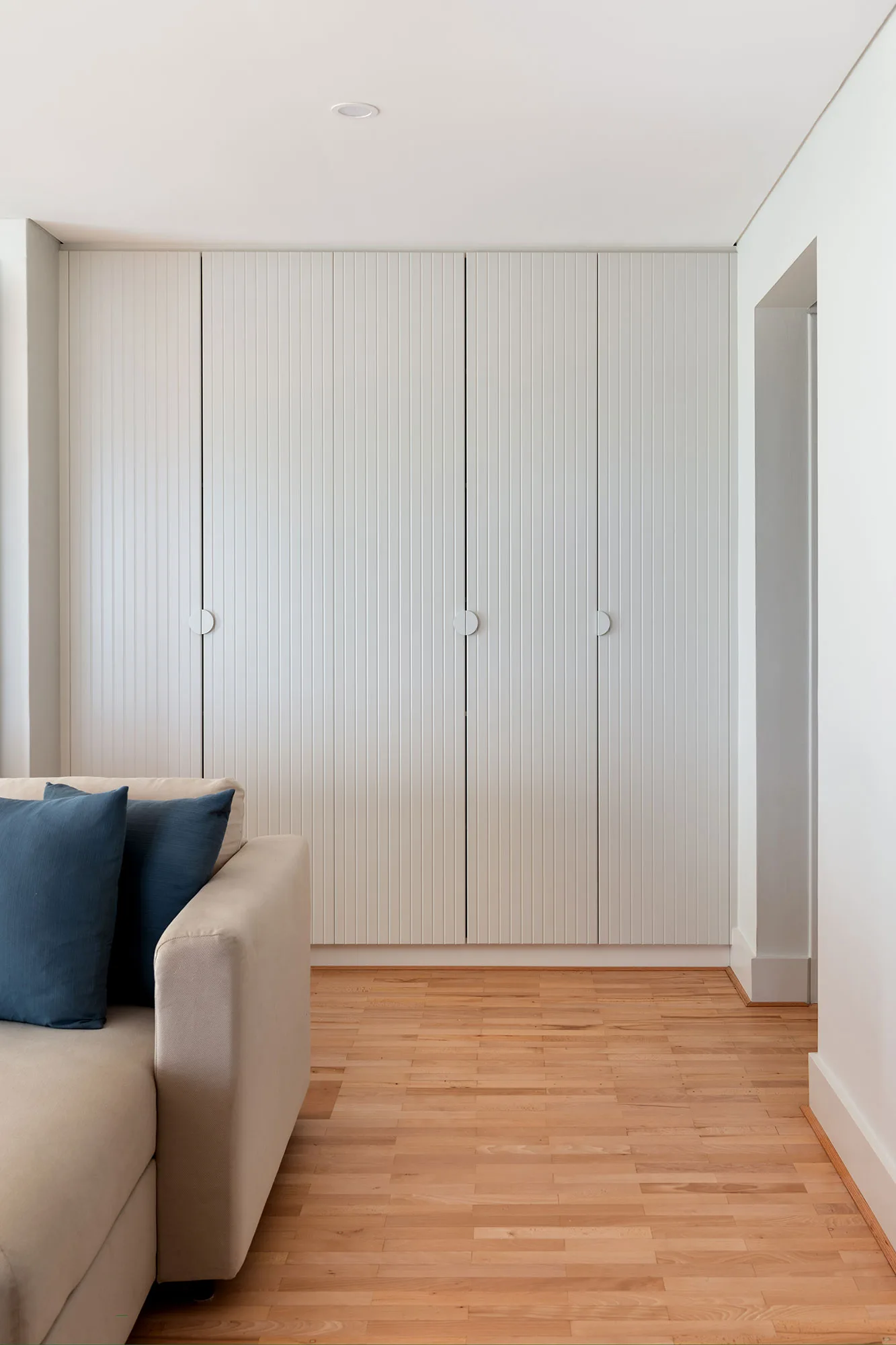 Cottesloe apartment — slatted built-in wardrobe in living area
