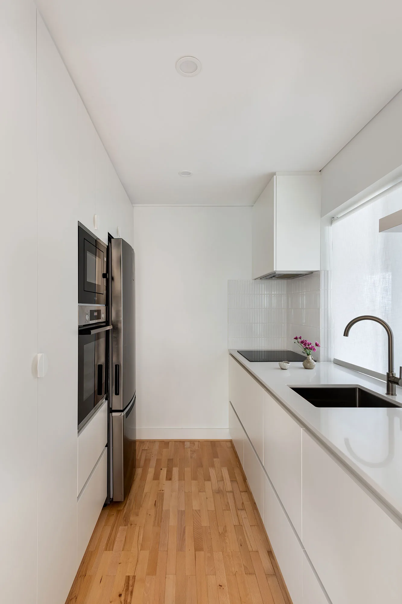 Cottesloe apartment — galley kitchen with stainless appliances