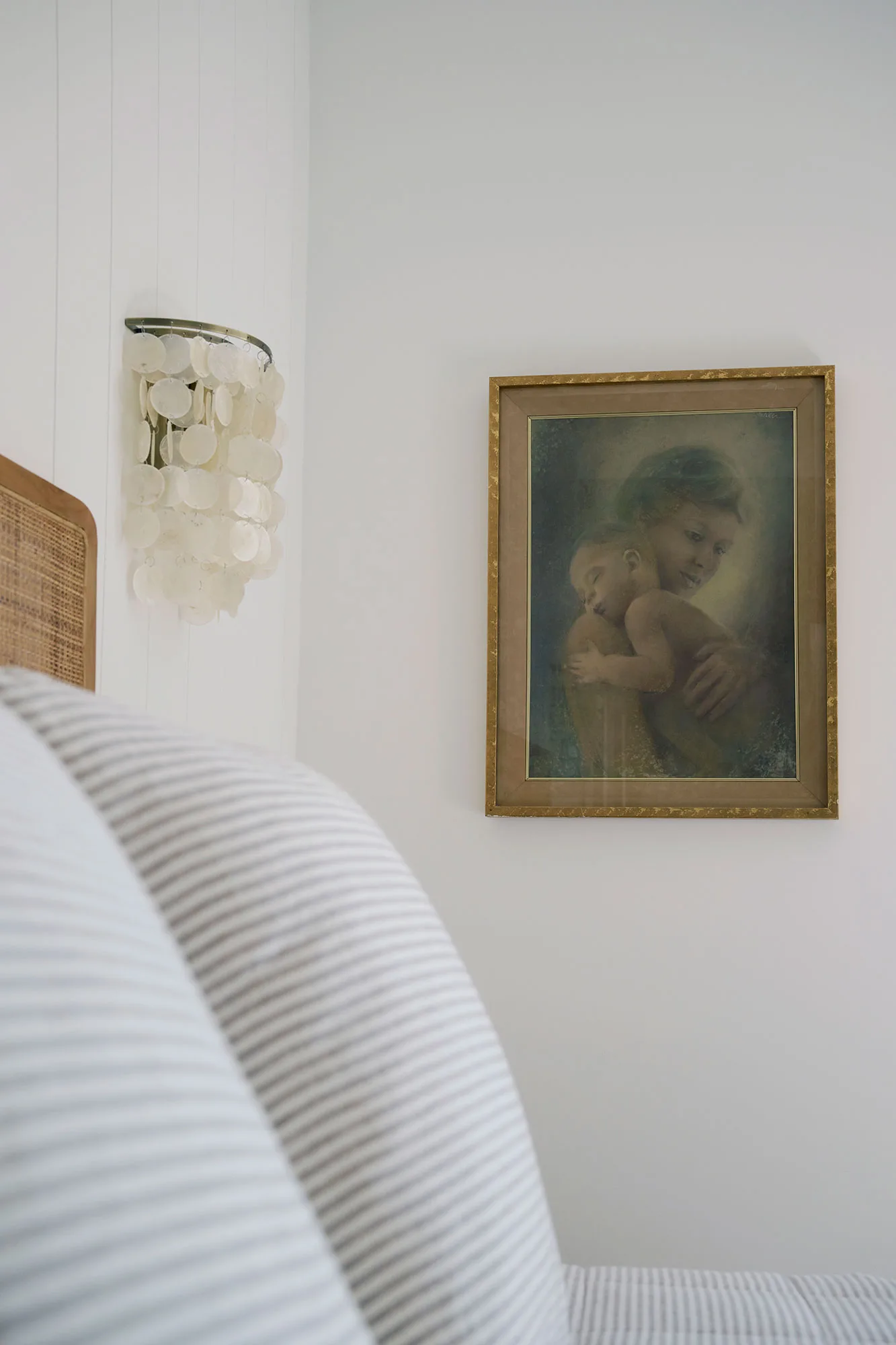 Exmouth I home — bedroom detail with capiz sconce and gilt framed vintage artwork