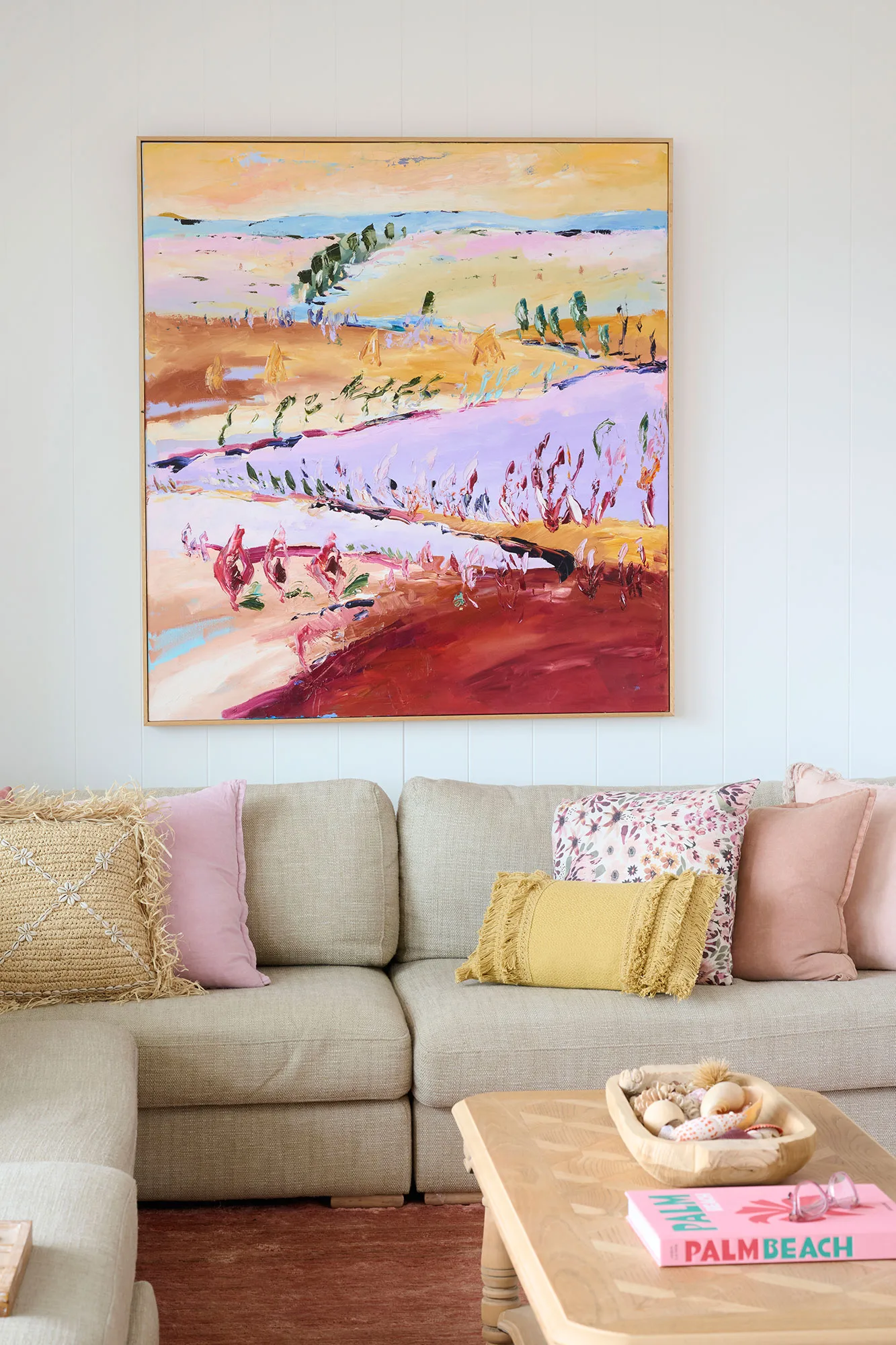 Exmouth I home — living room with abstract landscape painting, linen sectional and layered cushions