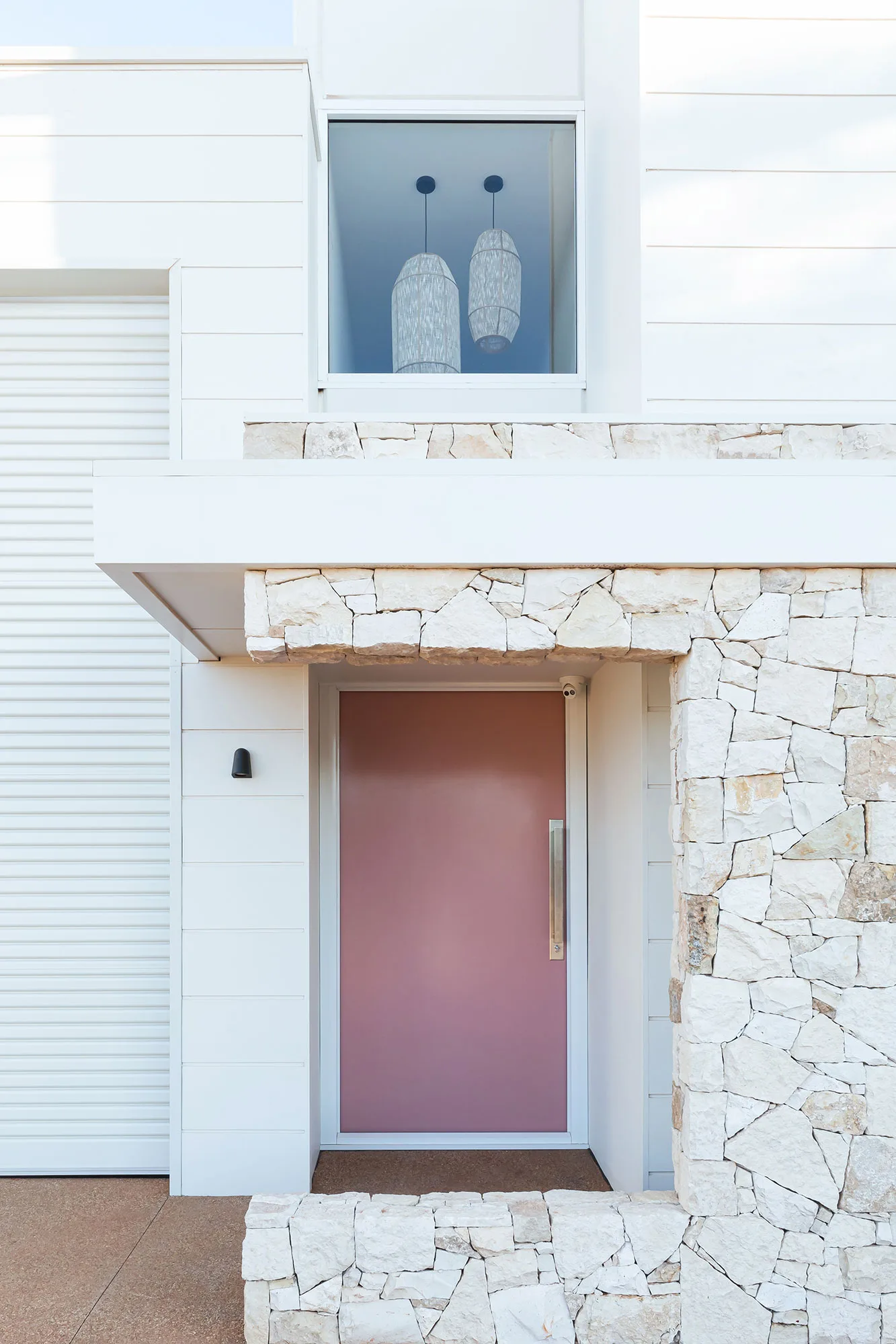 Exmouth II home — exterior with stone facade and pink front door