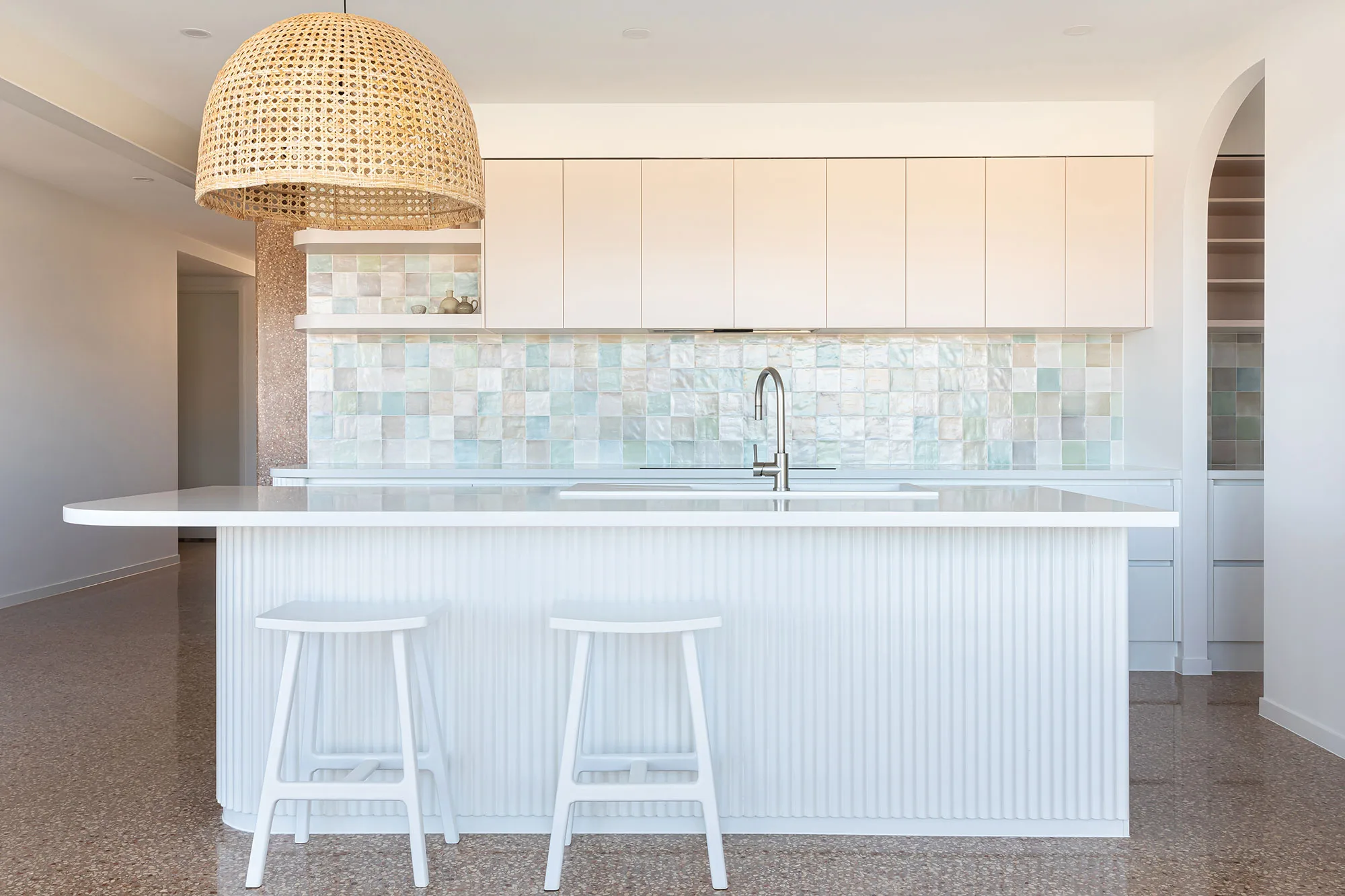 Exmouth II home — kitchen with fluted island, rattan pendant and iridescent tile splashback